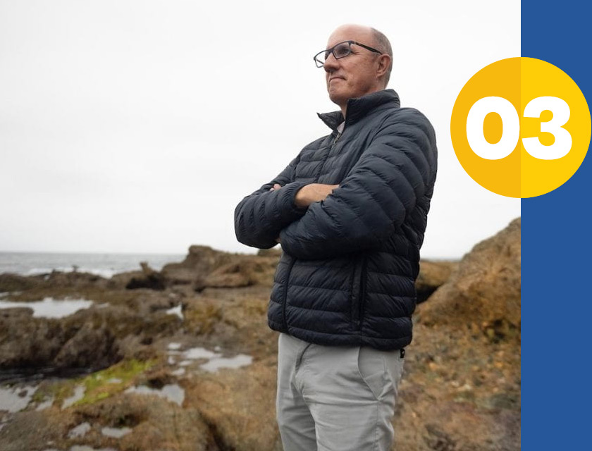 professor brett sanders standing and musing at beach