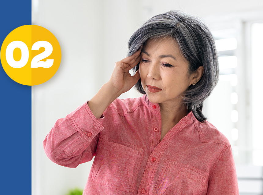middle-aged asian female showing signs of dizziness