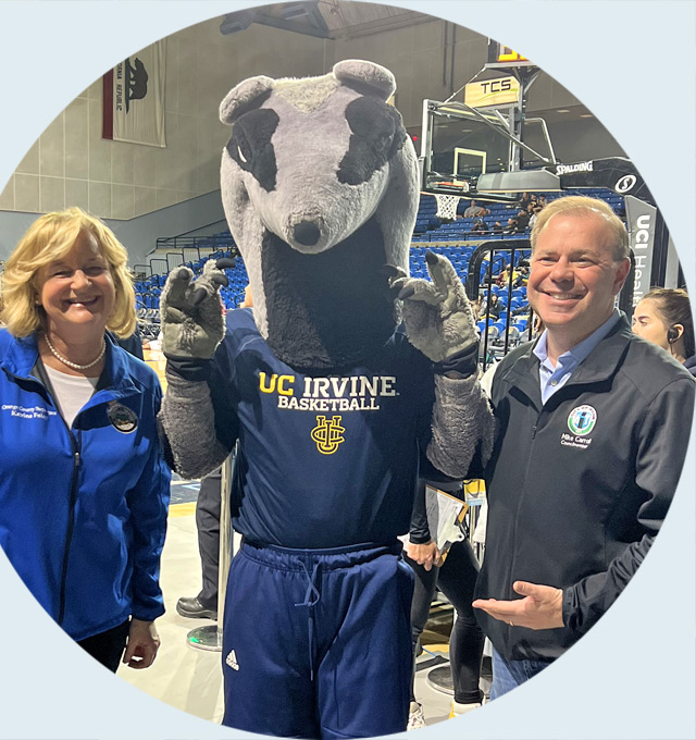 Councilmember Mike Carroll smiling next to UCI Antereater Mascot
