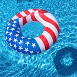 Circular floatie that looks like the U.S. flag in a pool.
