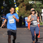 Two people running in the UCI Anti-Cancer Challenge.