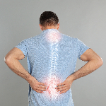 Image of male grasping his back with a layered image of his spinal cord.